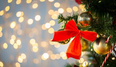 holidays, new year, decor and celebration concept - close up of christmas tree decorated with red...