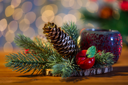 christmas, decoration, holidays and new year concept - close up of natural fir branch decoration and fir-cone and lantern on wooden tableの写真素材