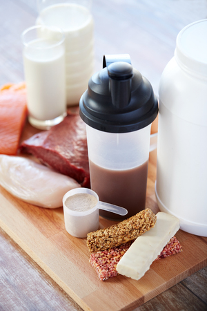 sport, fitness, healthy lifestyle, diet and people concept - close up of natural protein food and additive on wooden tableの写真素材