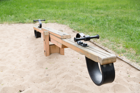 childhood, equipment and object concept - close up of swing or teeterboard on playground outdoorsの写真素材