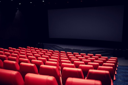 entertainment and leisure concept - movie theater or cinema empty auditorium with red seats