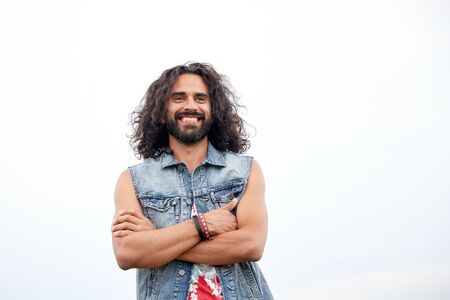 subculture, youth culture and people concept - smiling young hippie man in demin vest