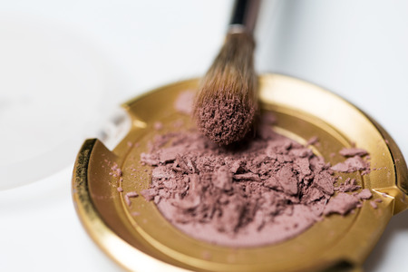 cosmetics, makeup and beauty concept - close up of makeup brush and eyeshadowの写真素材