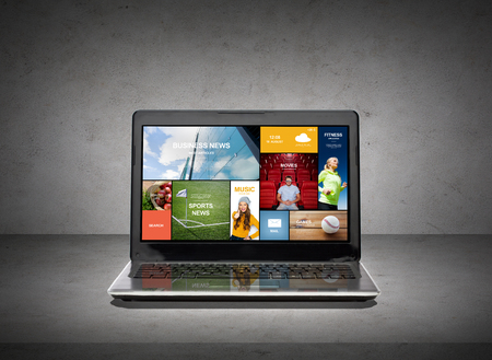 technology, media and electronics concept - laptop computer with news web pages on screenの写真素材