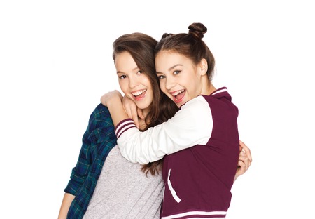 people, friends, teens and friendship concept - happy smiling pretty teenage girls huggingの写真素材