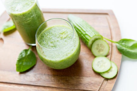 healthy eating, organic food and diet concept - close up of fresh green juice with celery on wooden tableの写真素材