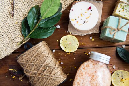 beauty, spa, therapy, natural cosmetics and wellness concept - close up of body care cosmetic products on woodの写真素材