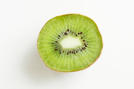 fruits, diet, food and objects concept - close up of ripe kiwi slice on tableの写真素材