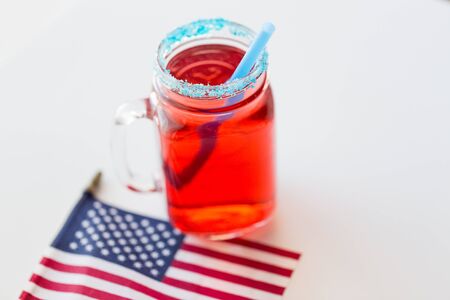 american independence day, celebration, patriotism and holidays concept - close up of juice glass and flag at 4th july party from topの写真素材