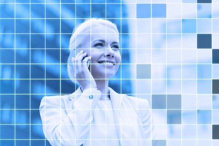 business, technology and people concept - smiling businesswoman with smartphone talking over office...