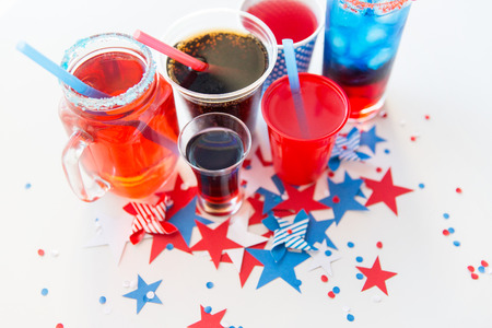 american independence day, celebration, patriotism and holidays concept - close up of cups and glasses with drinks on american independence day party from topの写真素材