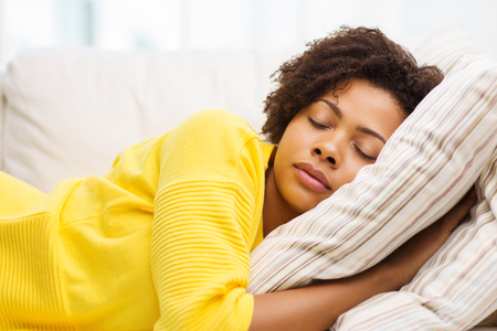 people, rest, comfort and leisure concept - african american young woman sleeping on sofa at home people, rest, comfort and leisure concept - african american young woman sleeping on sofa at home