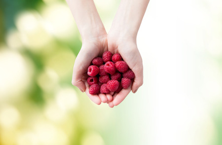 healthy eating, dieting, vegetarian food and people concept - close up of woman hands holding ripe...