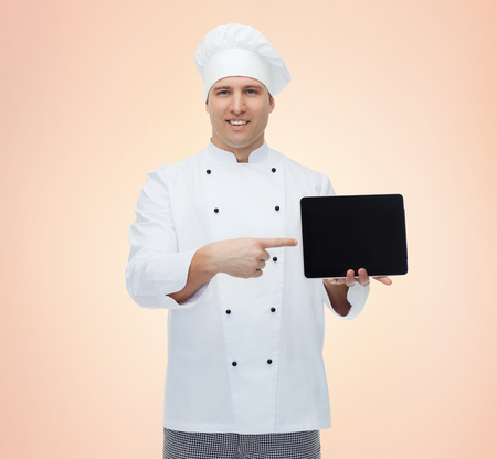 cooking, profession and people concept - happy male chef cook showing tablet pc computer black blank screen over beige backgroundの写真素材