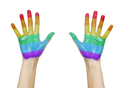 people, gay pride and homosexual concept - palms of human hands painted in rainbow coloursの写真素材