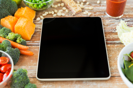 healthy eating, dieting, slimming and weigh loss concept - close up of black blank tablet pc screen and vegetablesの写真素材