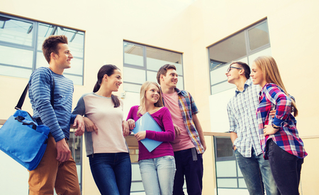 friendship, people and education concept - group of smiling students outdoorsの写真素材