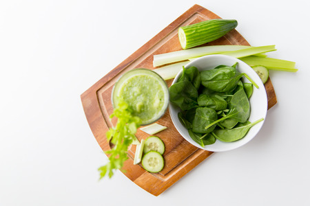 healthy eating, organic food and diet concept - close up of fresh green juice with celery on wooden tableの写真素材