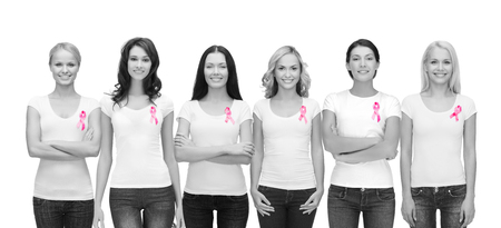 healthcare and medicine concept - group of smiling women in blank t-shirts with pink breast cancer awareness ribbonsの写真素材