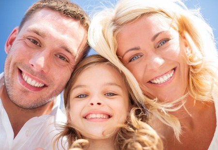 summer holidays, children and people concept - happy family with blue skyの写真素材