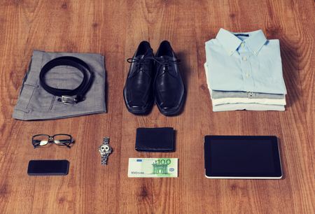 close up of formal male clothes and personal stuff on wooden table at homeの写真素材