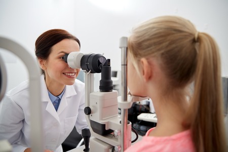 health care, medicine, people, eyesight and technology concept - optometrist with non contact...