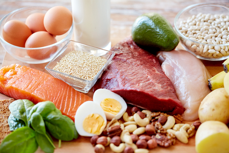 balanced diet, cooking, culinary and food concept - close up of different foodstuffs on table