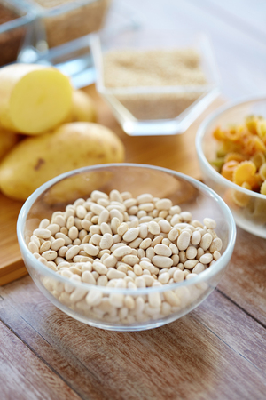 protein diet, cooking, culinary and food concept - close up of beans in glass bowl on tableの写真素材