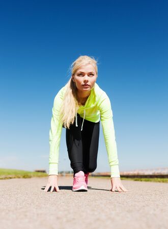 sport and lifestyle concept - woman doing running outdoorsの写真素材