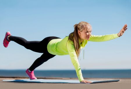 sport and lifestyle concept - woman doing sports outdoors