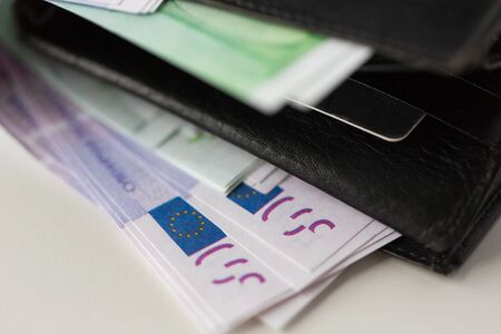 finance, investment, saving and cash concept - close up of euro paper money in wallet