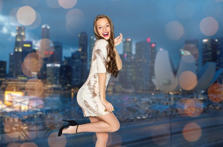 people, style, holidays, night life and fashion concept - happy young woman or teen girl in fancy...