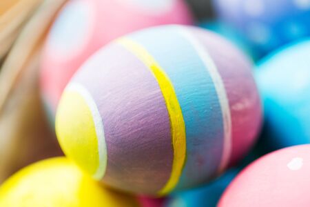 easter, holidays, tradition and object concept - close up of colored easter eggs