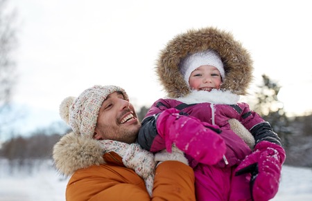 family, parenthood, fatherhood, season and people concept - happy smiling father and little girl in winter clothes outdoorsの写真素材