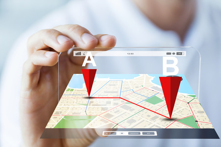 business, technology, navigation, location and people concept - close up of male hand holding and...