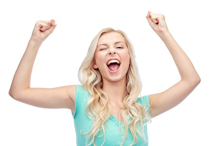emotions, expressions, success and people concept - happy young woman or teenage girl celebrating victoryの写真素材
