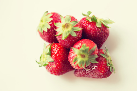 fruits, berries, diet, eco food and objects concept - juicy fresh ripe red strawberries on whiteの写真素材