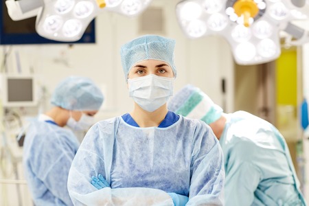 surgery, medicine and people concept - surgeon in operating room at hospitalの写真素材