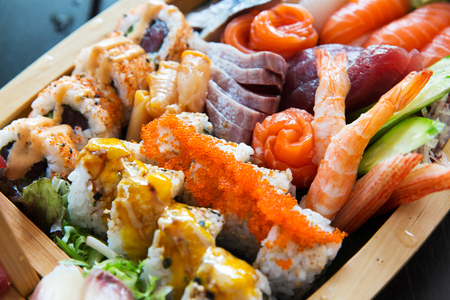 cooking, asian kitchen, seafood, eating and food concept - sushi set at restaurantの写真素材