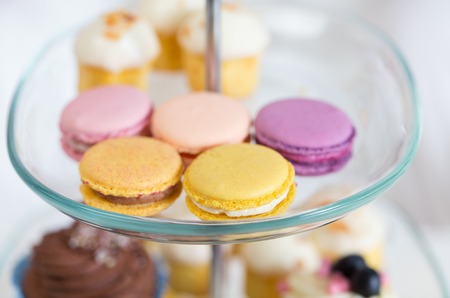 unhealthy eating, sweets, dessert, baking and junk food concept - close up of cake stand with...
