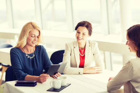 people, expenses, payment and lifestyle concept - happy women looking at restaurant billの写真素材