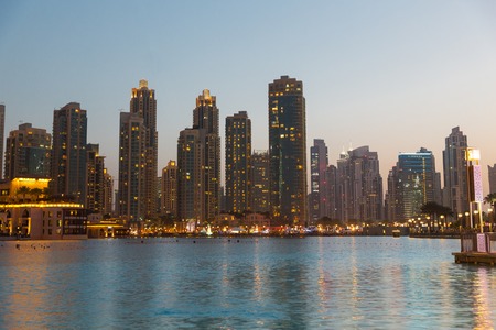 cityscape, travel, tourism and urban concept - Dubai business city district night lights and seafrontの写真素材