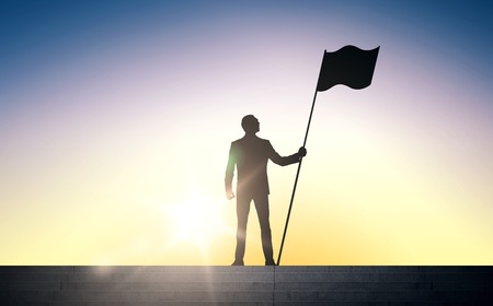 business, success, leadership, achievement and people concept - silhouette of businessman with flag standing on stairs over sun light backgroundの写真素材