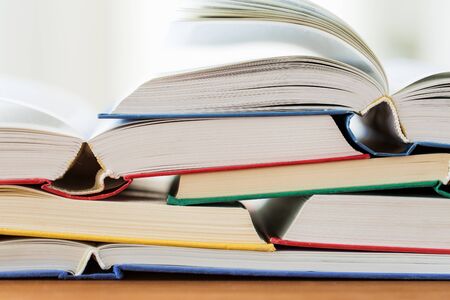education, school, literature, reading and knowledge concept - close up of books on wooden table