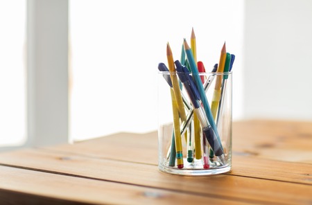 education, office supply, writing tools and object concept - close up of stand or glass with pens...