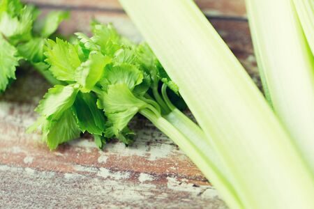diet, vegetable food, cooking and objects concept - close up of celery stems on wooden tableの写真素材
