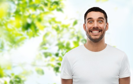 expression and people concept - man with funny face over green natural backgroundの写真素材