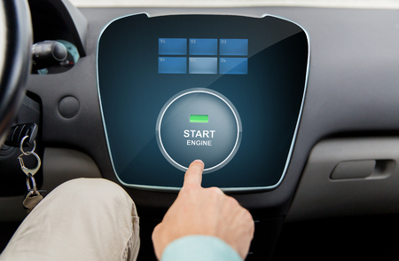 transport, driving, technology and people concept - close up of male hand using starter application...