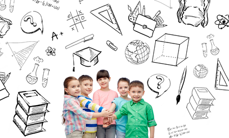 childhood, school, education, learning and people concept - happy little children with hands on top with doodlesの写真素材