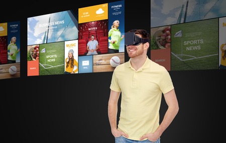 3d technology, virtual reality, mass media, entertainment and people concept - happy young man in...